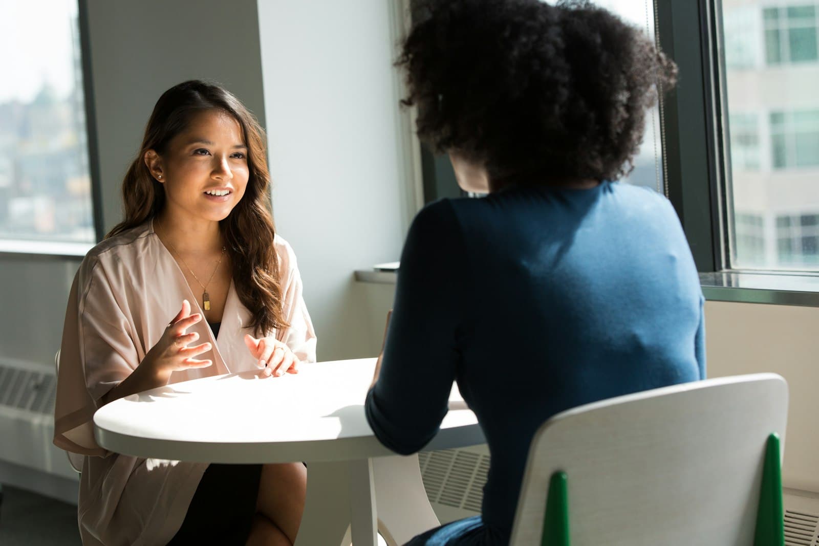 Two people having a calm, supportive mentoring conversation