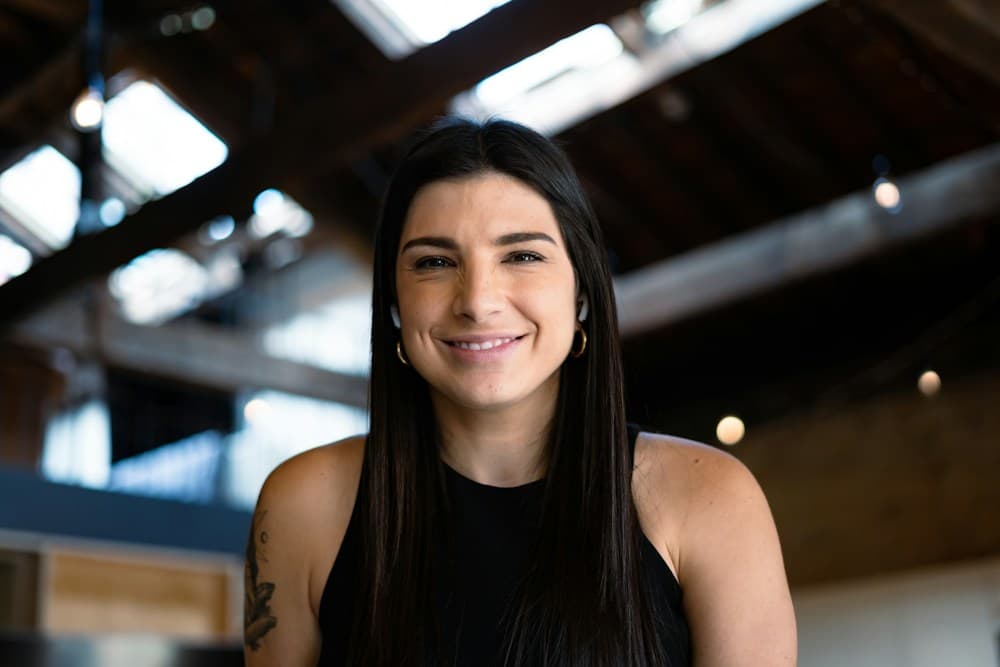 A smiling woman with a confident, ready-for-what's-next look
